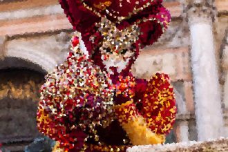 Colorful mosaic sculpture of a bird with red, orange, and yellow tiles.