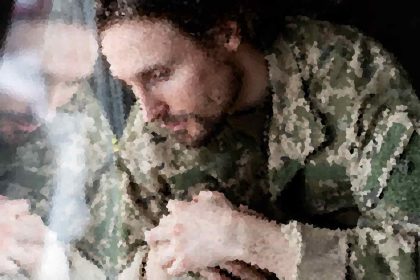 Two people kissing in a dark, outdoor setting, though the image is heavily pixelated and details are unclear.