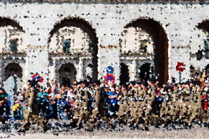 Crowd gathered in front of a white historic building with two large arches and a busy plaza.