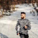 Man running along a snowy forest path in a gray jacket, blurred by pixelation, winter scene