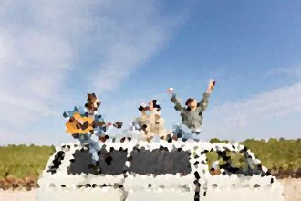 Three people celebrate on top of a white car, arms raised, on a sunny day with a rural landscape behind them.