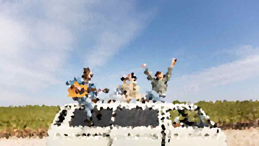 Three people celebrate on top of a white car, arms raised, on a sunny day with a rural landscape behind them.