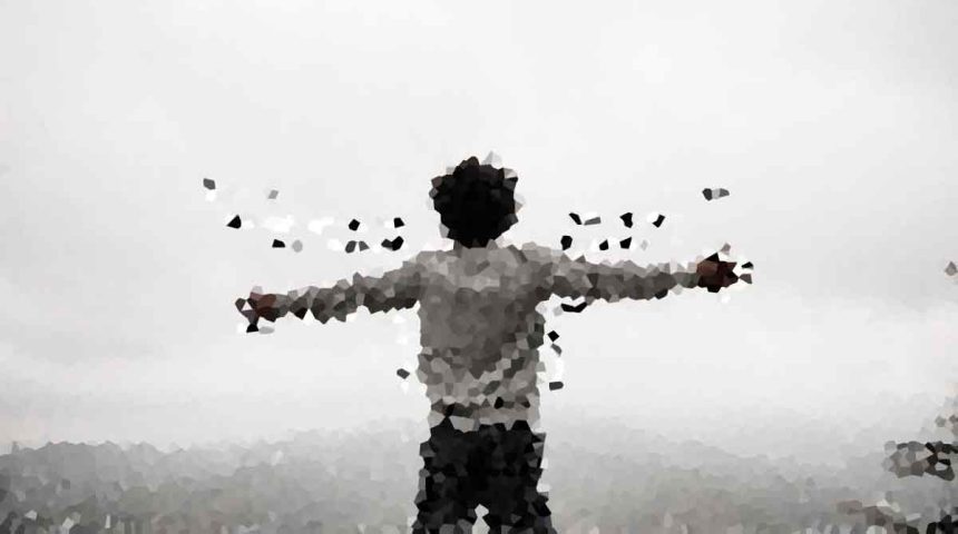 Person standing on a hilltop with arms outstretched, seen from behind in a grayscale low-poly style.