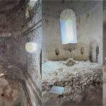 Interior of a ruined stone church with curved arches and exposed masonry.
