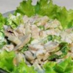 Bowl of chopped chicken salad on a bed of green lettuce.