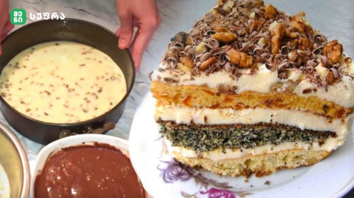 Layered cake with white frosting and chopped nuts on top, next to bowls of batter and sauce being prepared.