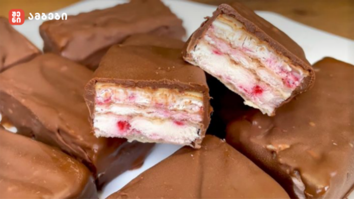 Chocolate-covered wafer candies with white cream and pink strawberry-like filling; a bar is cut in half to reveal the layers.