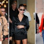 Three women wearing sunglasses in an urban setting: left in beige trench over white outfit, center in black satin blouse with mini skirt, right in red cardigan and jeans.