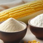 Corn on the cob with bowls of flour and cornmeal on a wooden board, ready for cooking (brand logo top left).