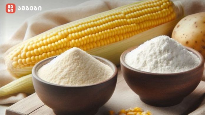 Corn on the cob with bowls of flour and cornmeal on a wooden board, ready for cooking (brand logo top left).