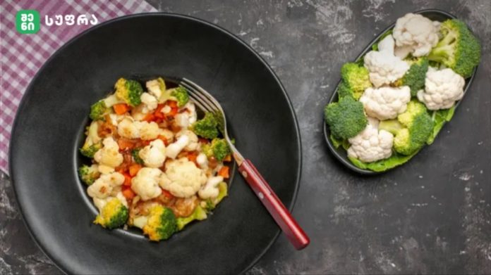 Black bowl filled with a vegetable medley (broccoli, cauliflower, carrots) and a red-handled fork; a separate plate shows broccoli and cauliflower florets.