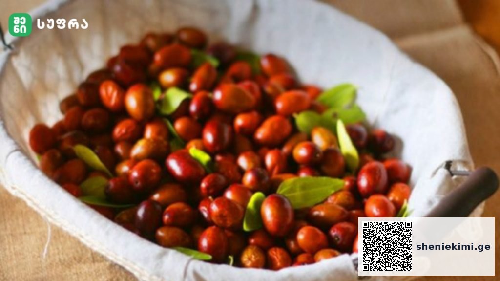 Basket of fresh red jujubes in a light cloth bag with green leaves nearby.