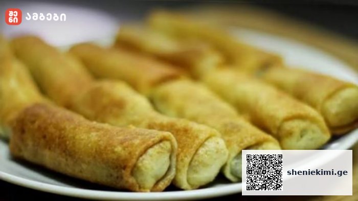 Plate of golden brown fried pastry rolls arranged on a white plate, with a crispy outer crust and pale filling visible at the ends.