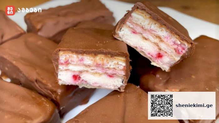 Chocolate-covered wafer candies with white cream and pink strawberry-like filling; a bar is cut in half to reveal the layers.