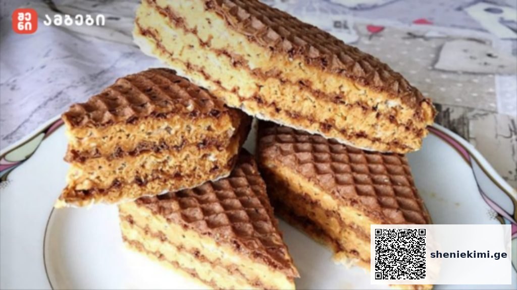 Stack of chocolate wafer cookies on a white plate, with layered filling and a ridged surface.