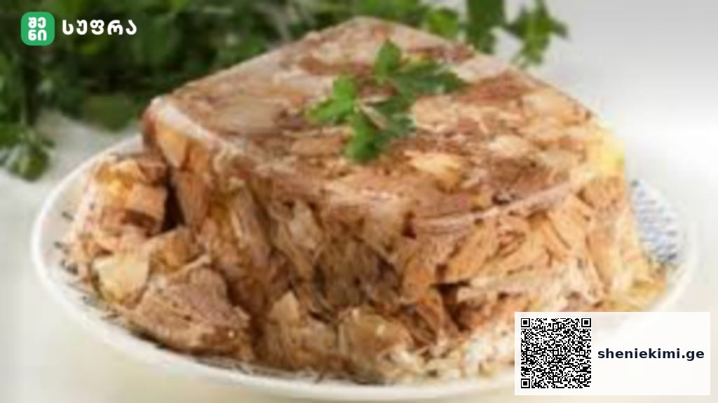 Pile of shredded roasted meat on a white plate, topped with a sprig of parsley.