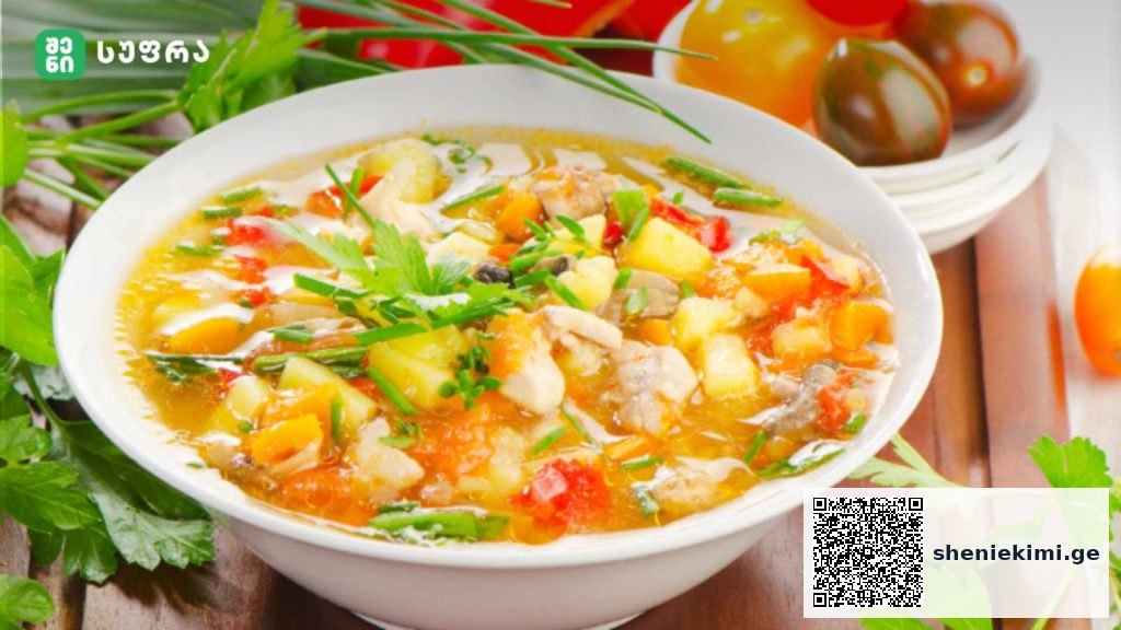 Bowl of hearty vegetable soup with potatoes, carrots, and herbs on a wooden table, garnished with parsley.