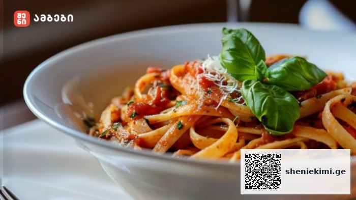 Bowl of spaghetti with tomato sauce, grated cheese, and fresh basil on a white plate.