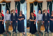 ბათუმის შოთა რუსთაველის სახელმწიფო უნივერსიტეტსა და Georgian Medical Journal-ს შორის სტრატეგიული თანამშრომლობის პერსპექტივები განიხილეს Four adults posing for a formal group photo in a room with draped curtains and flags behind them (Georgia and EU flags); two women in dark dresses and two men in smart attire stand side by side.